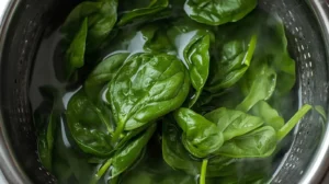 Once boiling, add a couple of large pinches of salt to the water, then add the baby spinach. Cook the spinach for about 30-60 seconds and quickly remove it with a skimmer, placing it in a colander to drain.