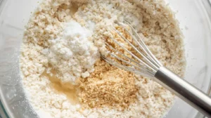 In a mixing bowl, combine rice flour, cornstarch, garlic powder (if using), and a pinch of salt. Mix well.