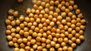 In a nonstick pan, add a little olive oil and toss in the drained chickpeas.